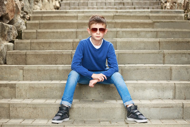 boy with shades on steps
